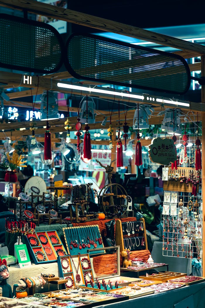 Colorful jewelry and crafts stall at an outdoor night market, showcasing vibrant accessories.