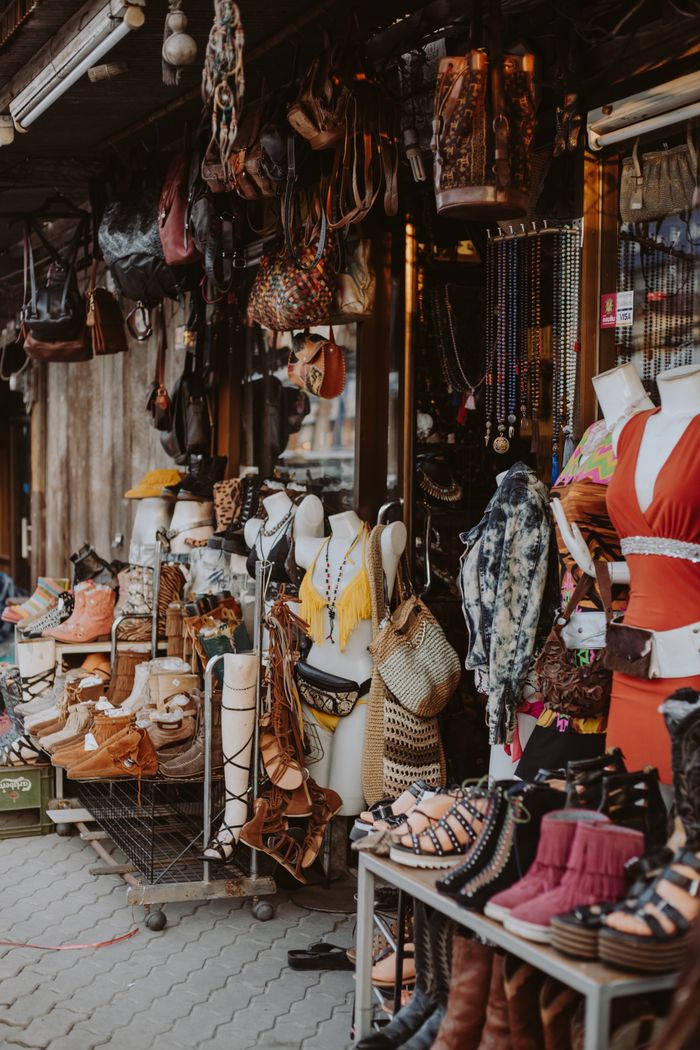 Vibrant street market stall showcasing diverse apparel and accessories, ideal for urban shopping scenes.